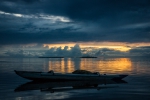 Moored small outrigger bangka in the sunset