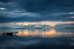 Small outrigger bangka in calm evening waters