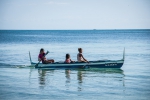 Kids in a boat speeding by