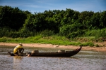 Boy helping his fisherman father at work