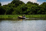 Father teaching his son secrets of fishing with a net