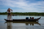 Fisherman in boxer shorts pulling out fishnet