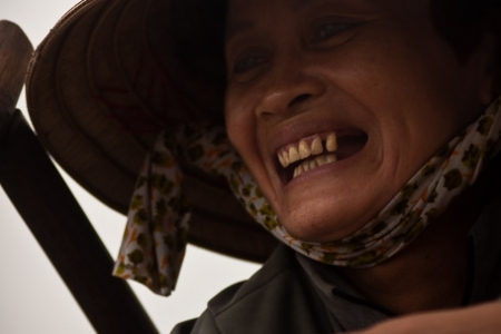 Smiling veggies seller