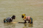 Two girls washing clothes