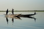 Pirogue drivers discussing directions on the Niger river near ferry crossing to Timbuktu, Mali. Photo by Marko Preslenkov.