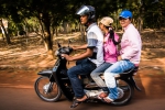 Family of three on a black Honda Wave