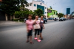 Three friends cautiously crossing the street