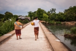 Lao ladies crossing old railway bridge