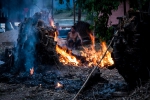 Lao man watching over fire