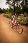 Wee Lao girl racing her red bicycle