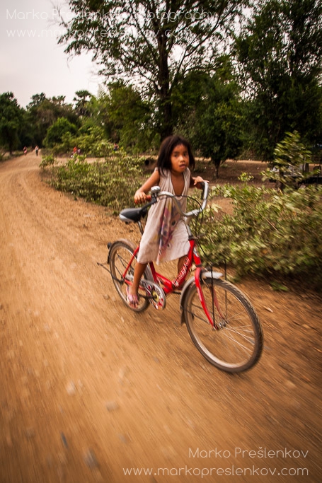 Wee Lao girl racing her red bicycle