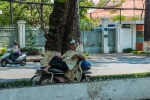 Lying on a motorbike in a shade