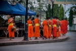 Monks rounding the street corner at alms procession