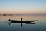 A Tuareg man returning home as a passanger in pirogue on Niger river at Tombouctou fleuve near Timbuktu, Mali. Photo by Marko Preslenkov.