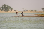 Two men washing on the banks of Niger river