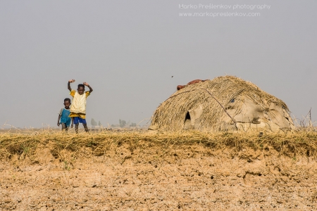 Kids next to a hut